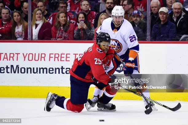 Devante Smith-Pelly of the Washington Capitals and Brock Nelson of the New York Islanders battle for the puck in the first period at Capital One...