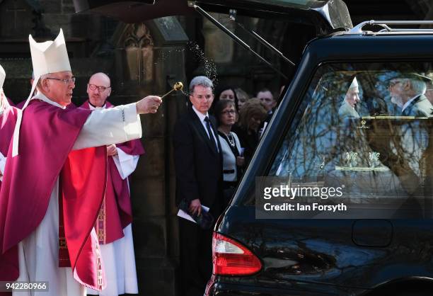 Member of the Catholic church blesses the coffin as members of the church gather after the funeral service of Cardinal Keith Patrick O'Brien,...
