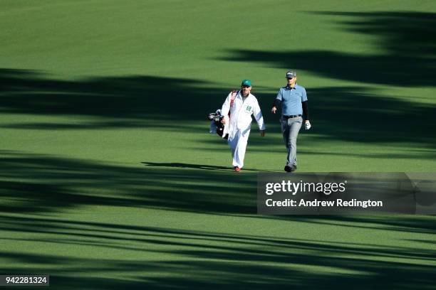 Brendan Steele of the United States walks on the second hole with caddie Christian Donald during the first round of the 2018 Masters Tournament at...