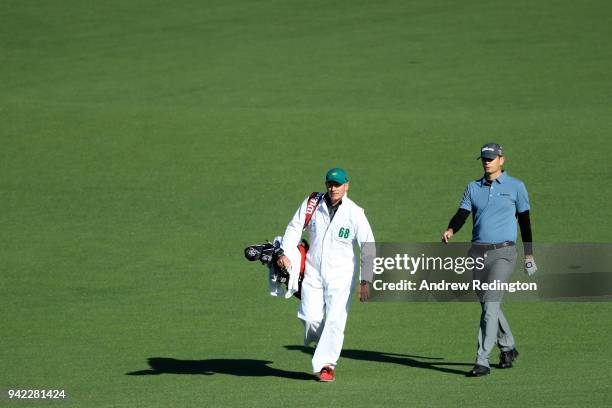 Brendan Steele of the United States walks on the second hole with caddie Christian Donald during the first round of the 2018 Masters Tournament at...