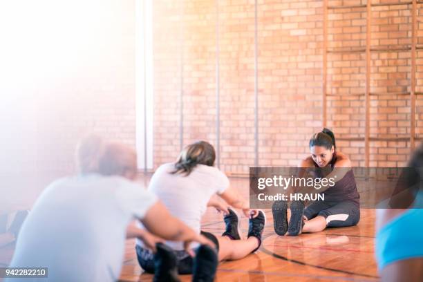 female soccer team and athletes exercising on in court or gym. - indoor soccer stock pictures, royalty-free photos & images