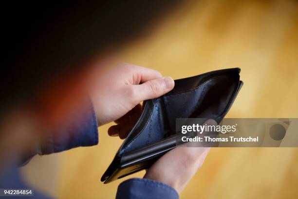 Berlin, Germany In this photo illustration a person opens an empty wallet on April 05, 2018 in Berlin, Germany.