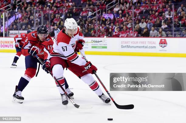 Trevor van Riemsdyk of the Carolina Hurricanes and Jakub Vrana of the Washington Capitals battle for the puck in the first period at Capital One...