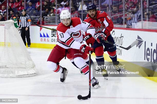 Trevor van Riemsdyk of the Carolina Hurricanes skates with the puck against Alex Ovechkin of the Washington Capitals in the second period at Capital...