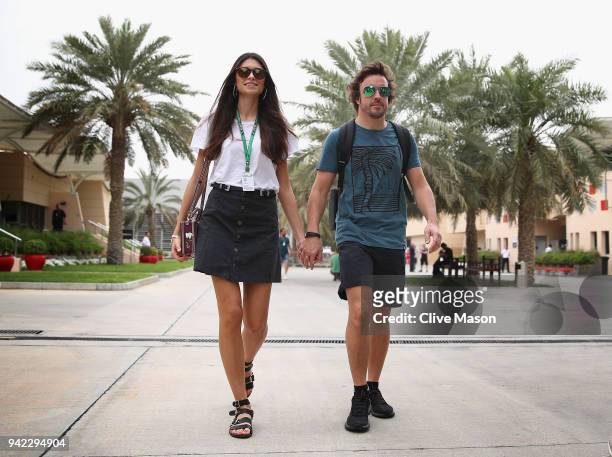 Fernando Alonso of Spain and McLaren F1 walks in the Paddock with girlfriend Linda Morselli during previews ahead of the Bahrain Formula One Grand...