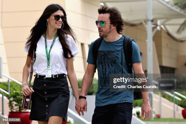 Fernando Alonso of Spain and McLaren F1 walks in the Paddock with girlfriend Linda Morselli during previews ahead of the Bahrain Formula One Grand...