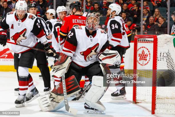 Antti Raanta of the Arizona Coyotes looks at the scoreboard in an NHL game on April 3, 2018 at the Scotiabank Saddledome in Calgary, Alberta, Canada.