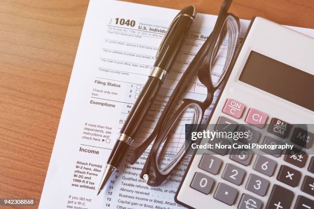 work space with tax form - calculator tax forms stockfoto's en -beelden