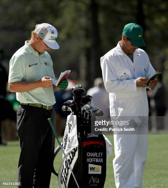 Charley Hoffman of the United States prepares to play a shot on the first hole alongside his caddie Brett Waldman during the first round of the 2018...