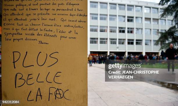 Quotations from US philosopher H.D. Thoreau and a slogan reading "A better University" are pictured on a wall as students gather for a general...