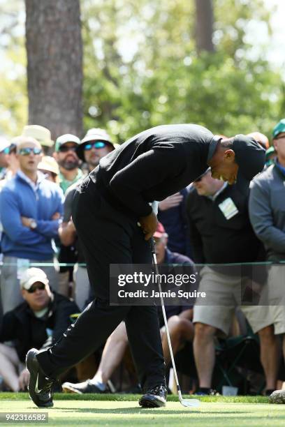 Tiger Woods of the United States reacts to his tee shot on the fourth hole during the first round of the 2018 Masters Tournament at Augusta National...