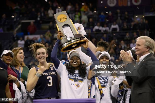 Finals: Notre Dame Arike Ogunbowale victorious, holding up National Championship trophy with teammates after winning game vs Mississippi State at...