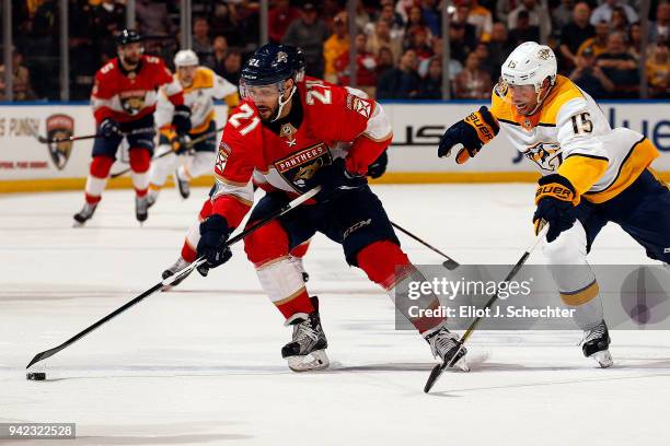 Vincent Trocheck of the Florida Panthers skates with the puck against Craig Smith of the Nashville Predators at the BB&T Center on April 3, 2018 in...