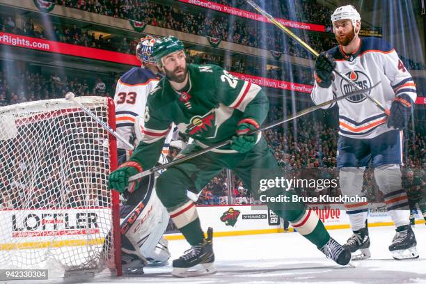 Zack Kassian and Cam Talbot of the Edmonton Oilers defend against Daniel Winnik of the Minnesota Wild during the game at the Xcel Energy Center on...