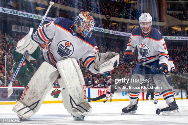 Cam Talbot and Darnell Nurse of the Edmonton Oilers defend against the Minnesota Wild during the game at the Xcel Energy Center on April 2, 2018 in...