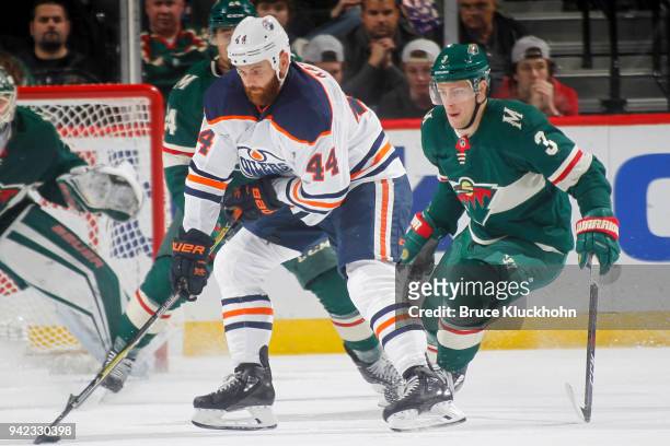 Zack Kassian of the Edmonton Oilers skates with the puck while Charlie Coyle of the Minnesota Wild defends during the game at the Xcel Energy Center...