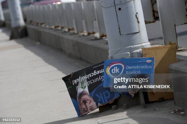 Distroyed election placard is seen with a portrait of a former Hungarian Prime Minister of Ferenc Gyurcsany of Democratic Coalition Party on Petofi...
