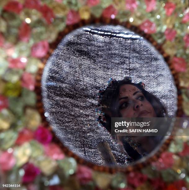 An Iraqi Kurdish woman attends a cultural festival near Maqlub Mountains, 30 km northeast of Mosul, on April 5, 2018.