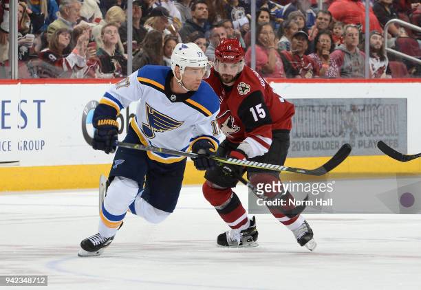 Brad Richardson of the Arizona Coyotes battles for position with Jaden Schwartz of the St Louis Blues at Gila River Arena on March 31, 2018 in...