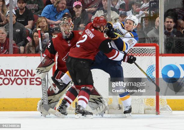 Luke Schenn of the Arizona Coyotes battles for position with Alexander Steen of the St Louis Blues in front of Coyotes goaltender Antti Raanta at...