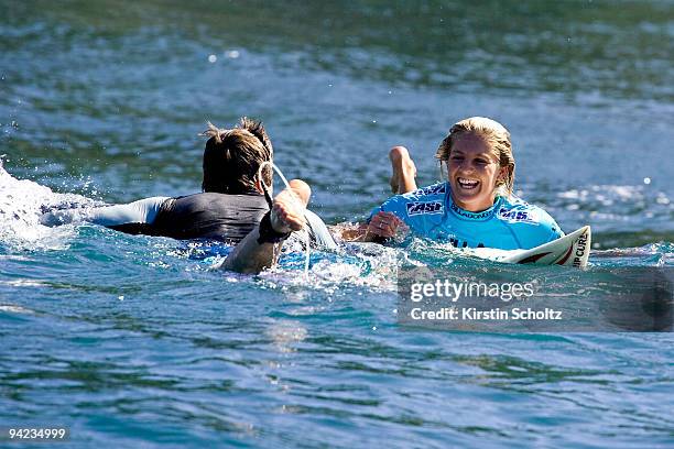 Stephanie Gilmore of Australia is congratulated by her caddy Neil Ridgeway of Australia after winning her semifinal heat at the Billabong Pro Maui on...