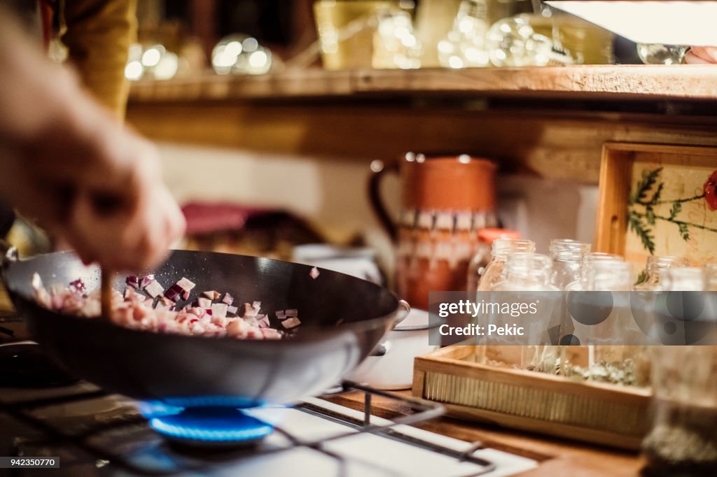 Man preparing pasta on gas stove