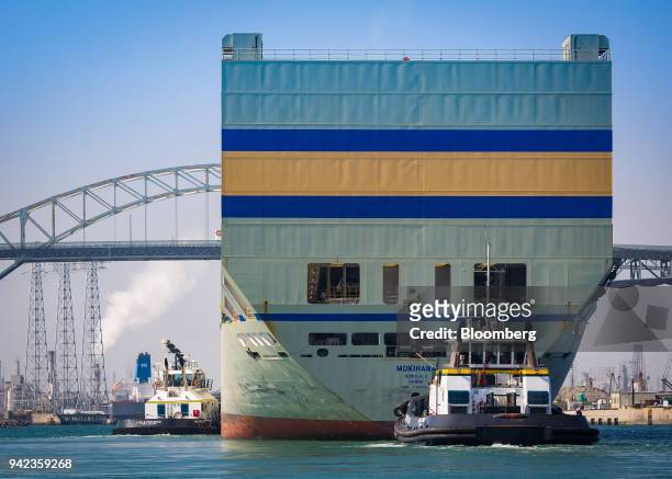 Tugboats guide the Matson Inc. Mokihana cargo ship into the Port of Long Beach in Long Beach, California, U.S., on Wednesday, April 4, 2018. The...