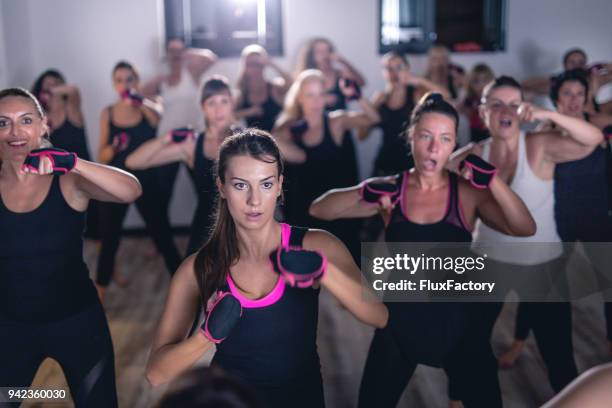 gorgeous group of women exercising together - boxing training stock pictures, royalty-free photos & images