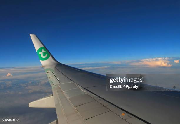 transavia airplane wing wih logo. - transasia airways stock pictures, royalty-free photos & images