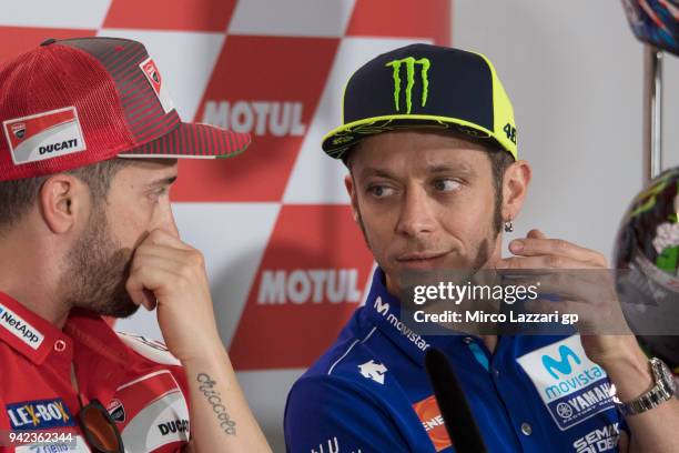 Valentino Rossi of Italy and Movistar Yamaha MotoGP speaks with Andrea Dovizioso of Italy and Ducati Team during the press conference pre-event...