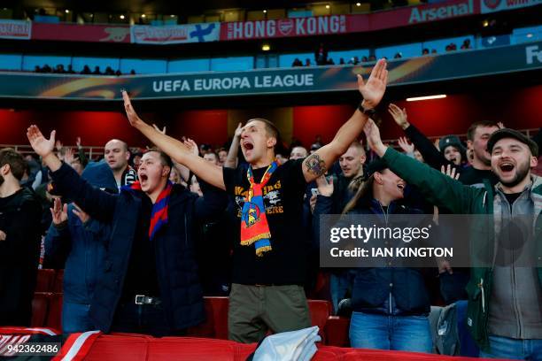 Fans chant ahead of the UEFA Europa League first leg quarter-final football match between Arsenal and CSKA Moscow at the Emirates Stadium in London...