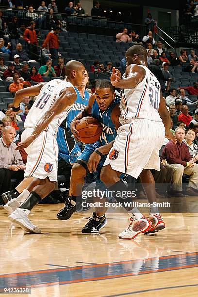 Jameer Nelson of the Orlando Magic drives the ball between Raja Bell and Raymond Felton of the Charlotte Bobcats during the game on November 10, 2009...