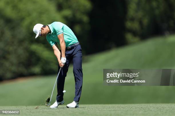 Haotong Li of China plays his second shot on the fifth hole during the first round of the 2018 Masters Tournament at Augusta National Golf Club on...
