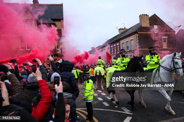 Fans of Liverpool let of flares as they await the arrival of the Manchester City team bus prior to the UEFA Champions League Quarter Final first leg...