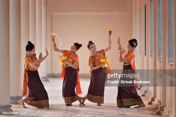 thai girls splashing water during festival songkran - cambodia water festival stock pictures, royalty-free photos & images