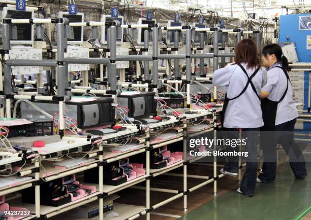 Employees inspect Fujitsu Ltd. Computer servers at the Fujitsu Isotec Ltd. Plant in Fukushima Prefecture, Japan, on Wednesday, Dec. 9, 2009. Orders...