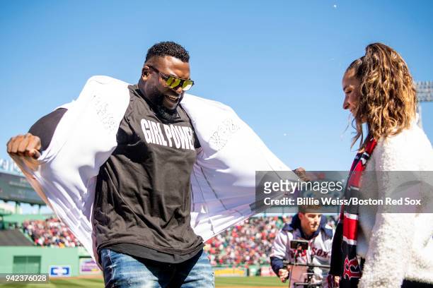 Former designated hitter David Ortiz of the Boston Red Sox reveals a shirt displaying a 'Girl Power' message alongside olympic gymnast Aly Raisman...