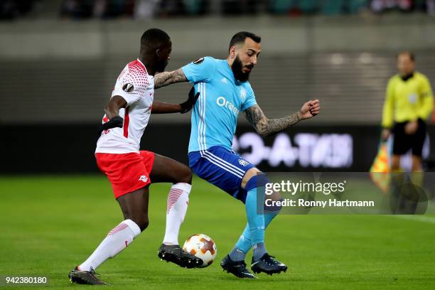 Ibrahima Konate of RB Leipzig vies with Kostas Mitroglou of Olympique Marseille during the UEFA Europa League quarter final leg one match between RB...