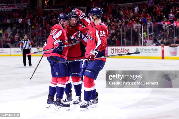 Jakub Vrana of the Washington Capitals celebrates with Evgeny Kuznetsov and Alex Chiasson after scoring a first period goal against the Colorado...