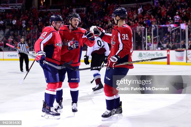 Jakub Vrana of the Washington Capitals celebrates with Evgeny Kuznetsov and Alex Chiasson after scoring a first period goal against the Colorado...