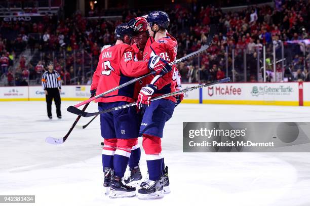 Jakub Vrana of the Washington Capitals celebrates with Evgeny Kuznetsov and Alex Chiasson after scoring a first period goal against the Colorado...