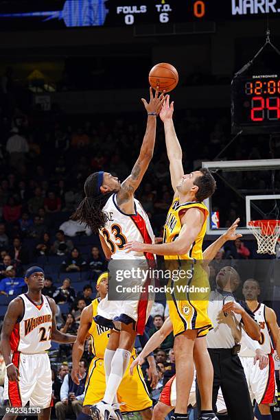 Mikki Moore of the Golden State Warriors and Jeff Fosger of the Indiana Pacers battle for a jump ball during the game at Oracle Arena on November 30,...