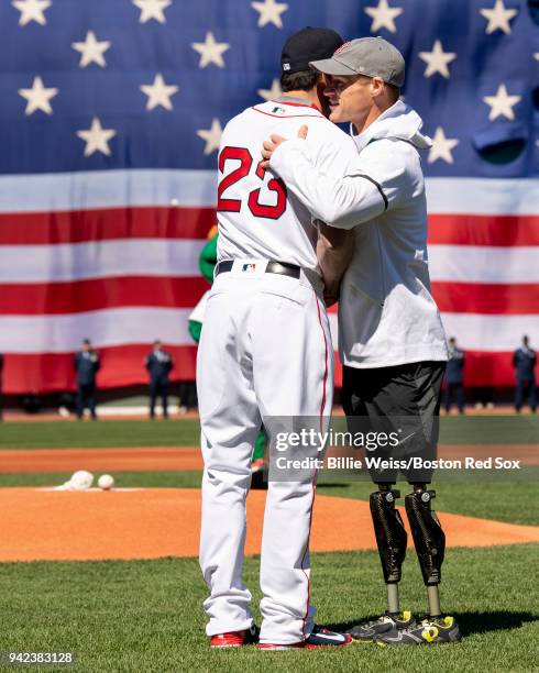 Nordic skiing Paralympic Medalist Dan Cnossen of the United States is congratulated by Blake Swihart of the Boston Red Sox after throwing out the...