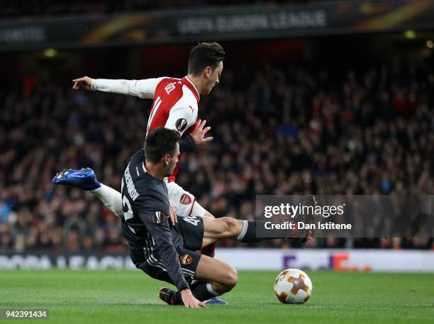 Mesut Ozil of Arsenal is fouled by Georgi Schennikov of CSKA Moskva for a penalty during the UEFA Europa League quarter final first leg match between...