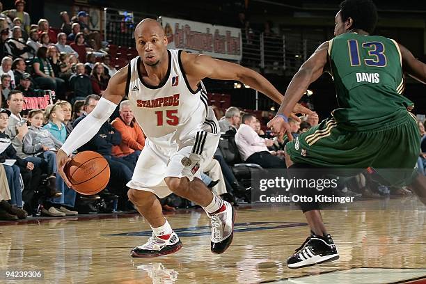 Sundiata Gaines of the Idaho Stampede moves the ball against Chris Davis of the Reno Bighorns during the D-League game at Qwest Arena on November 28,...