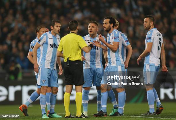 Marco Parolo with his teammates of SS Lazio reacts against the referee Ovidiu Hategan during the UEFA Europa League quarter final leg one match...