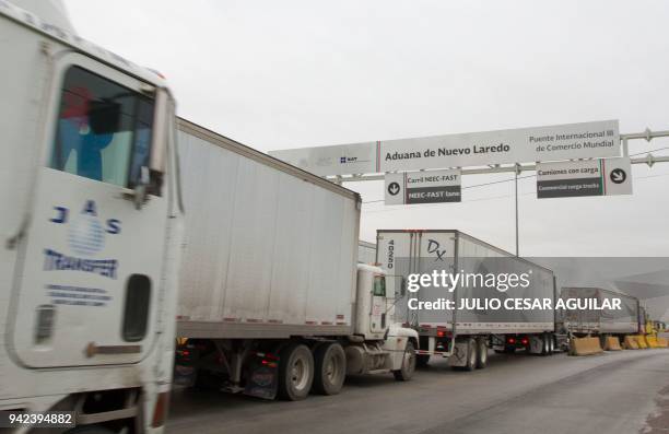 Commercial cargo trucks cross the fourteen-lane World Trade International Bridge in Nuevo Laredo, Tamaulipas, in Mexico, and Laredo in Texas, US,...