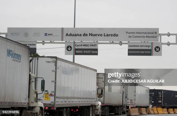 Commercial cargo trucks cross the fourteen-lane World Trade International Bridge in Nuevo Laredo, Tamaulipas, in Mexico, and Laredo in Texas, US,...