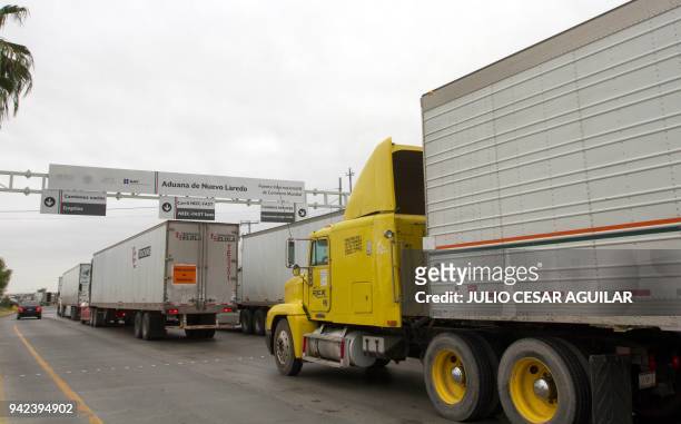 Commercial cargo trucks cross the fourteen-lane World Trade International Bridge in Nuevo Laredo, Tamaulipas, in Mexico, and Laredo in Texas, US,...