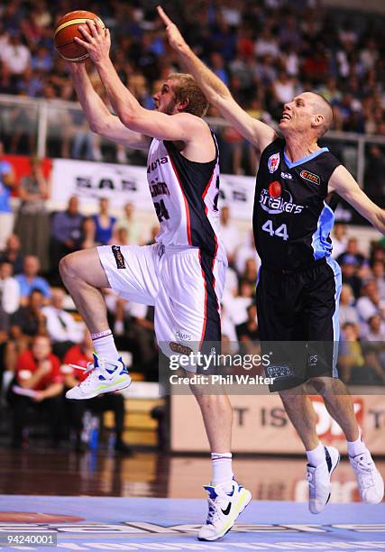 Jesse Wagstaff of the Perth Wildcats lays up the ball under pressure from John Rillie of the New Zealand Breakers during the round 12 NBL match...